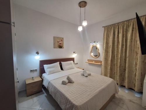 a bedroom with a bed with two towels on it at Manolas Sunset View in Glinádhon