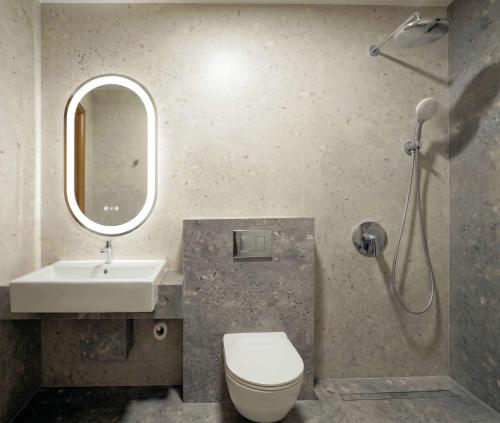 a bathroom with a sink and a toilet and a mirror at Golden Beach, Gerakini in Gerakini