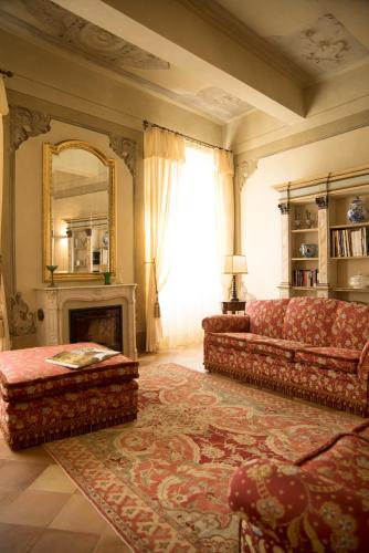 a living room with a couch and a fireplace at Le Case Di San Vitale in Ravenna