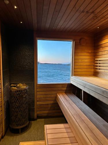 a sauna with a window with a view of the ocean at Sandvik Gästhamn & Camping in Kökar