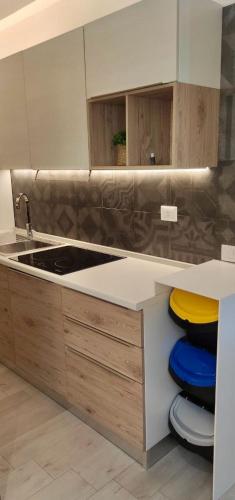 a kitchen with a sink and a counter top at Live Home Rooms in Villasimius