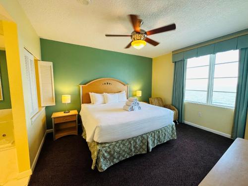 a bedroom with a bed and a ceiling fan at Ocean Walk Resort in Daytona Beach