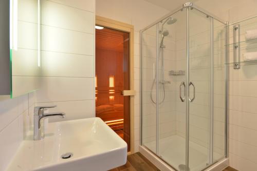 a bathroom with a sink and a shower at Chalet Reiteralm- SKI-IN SKI-OUT in Schladming