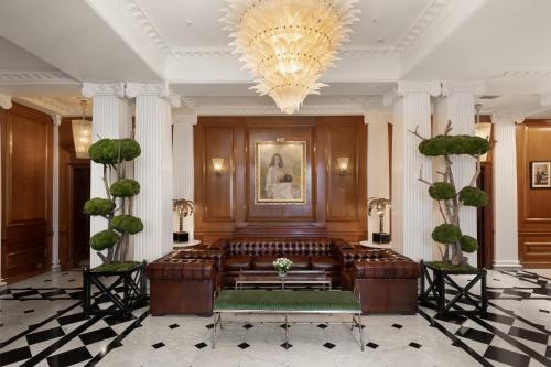 a lobby with a couch and a chandelier at The Chesterfield Mayfair in London