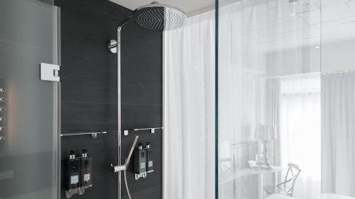 a bathroom with a shower with a glass door at Ruby Frida Hotel Stockholm by IHG in Stockholm