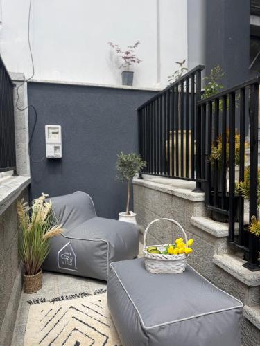 a balcony with two bean bags and a basket of fruit at Liams Cozy Villa in Korçë