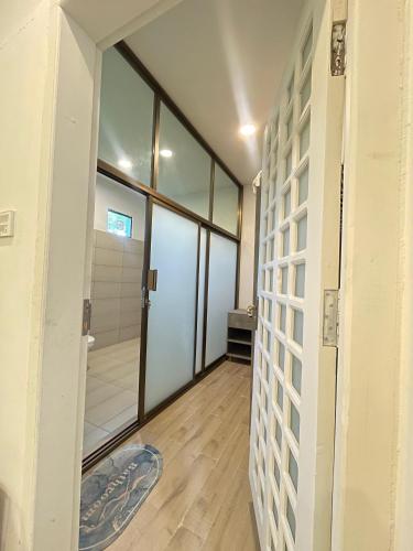 a hallway with a door leading to a bathroom at The Northleaf Cottage in Skardu