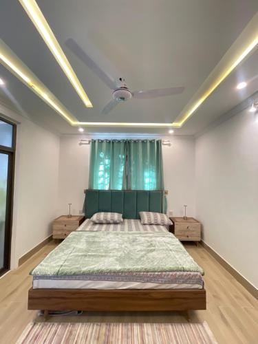 a bedroom with a large bed and a window at The Northleaf Cottage in Skardu