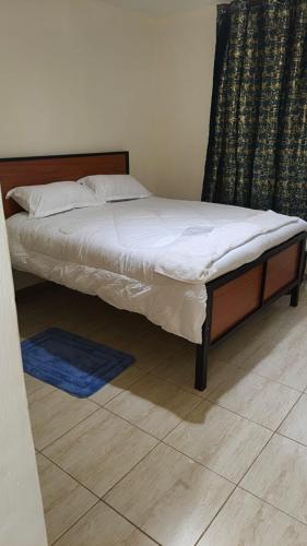 a bed sitting in a room with at Serenity Breeze in Ongata Rongai 