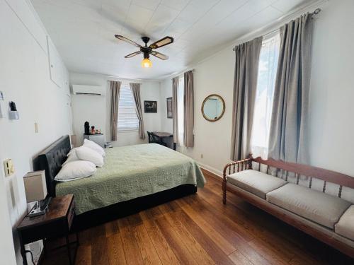 a bedroom with a bed and a ceiling fan at Nestle Inn in Hermann