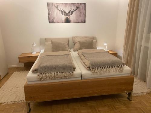 a bed with two pillows on it in a room at Ferienwohnung Servus in Traunstein