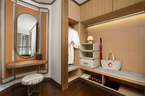 a dressing room with a mirror and a stool at Centara Grand Beach Resort Hua Hin in Hua Hin