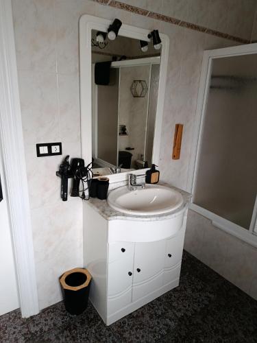 a bathroom with a sink and a mirror at Casa el moral 2 in Castillejo de Martín Viejo