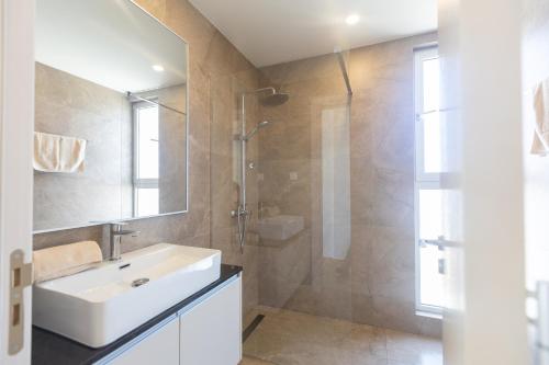 a bathroom with a white sink and a shower at Mythical Blue Villas in Protaras