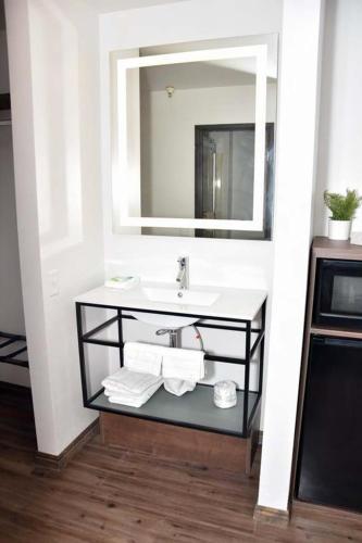 a bathroom with a sink and a mirror at Eagle Peak Lodge & Cabins in Ashton