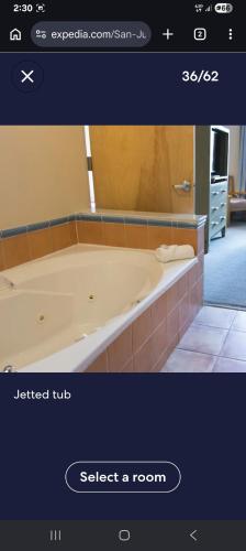 a bathroom with a bath tub in a room at Dorado Del Mar Beach Resort in Dorado