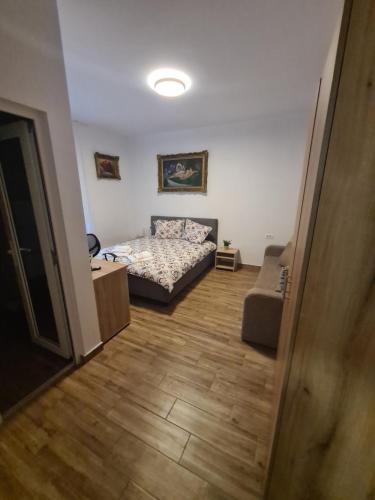 a small bedroom with a bed and a couch at Rusu Sirianu rooms in Timişoara