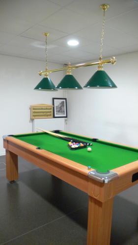 a pool table in a room with afits at Residence Adrechas et Spa in La Colmiane