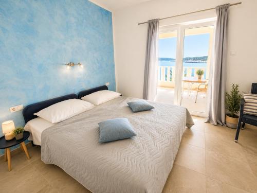 a bedroom with a bed with a view of the ocean at Ap AS in Rogoznica