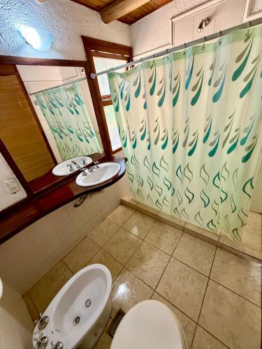 a bathroom with a toilet and a sink at Piedra Serrana in San Antonio de Arredondo
