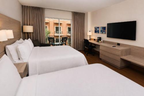 a hotel room with two beds and a flat screen tv at Holiday Inn Express - Monterrey - Tecnologico by IHG in Monterrey