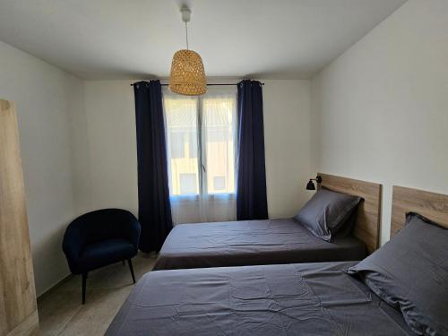 a bedroom with two beds and a window at Appartements sur l'ile de Porquerolles in Porquerolles