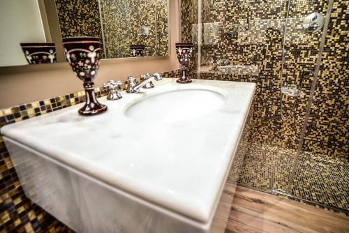 a bathroom with a white sink and a shower at Le Case Di San Vitale in Ravenna