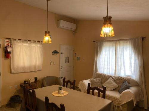 a living room with a table and a couch at Casa Ayacucho in Alta Gracia