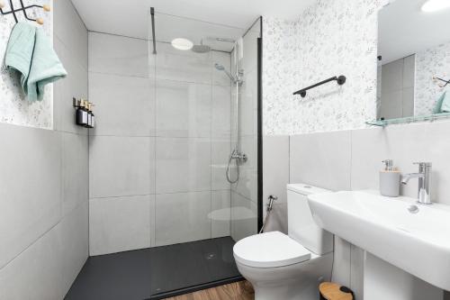 a bathroom with a shower and a toilet and a sink at Casa Nube in Corralejo