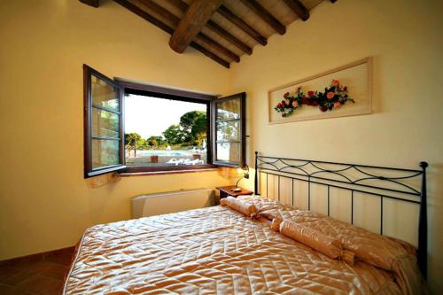 a bedroom with a large bed with a window at AgriResort Spa Glamping Poggio Di Montedoro in Montefiascone
