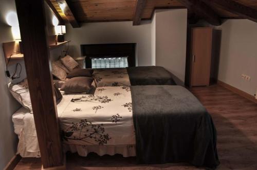 a bedroom with a large bed in a room at LA CASA DEL REBOTE in Acedo
