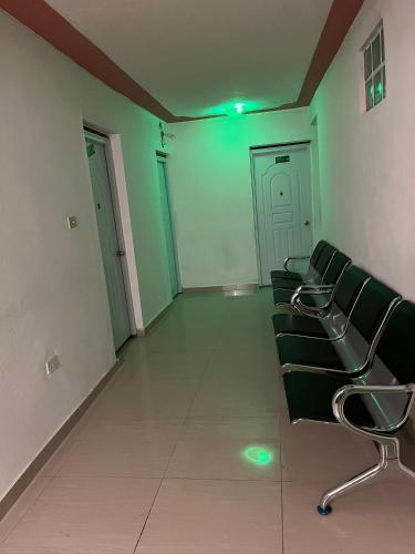 an empty room with chairs in a building at BAYO HOTEl in Cap-Haïtien
