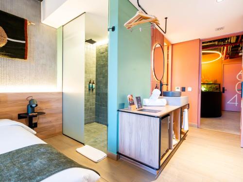 a bathroom with a sink and a shower at Hunters Hotel Medellin in Medellín
