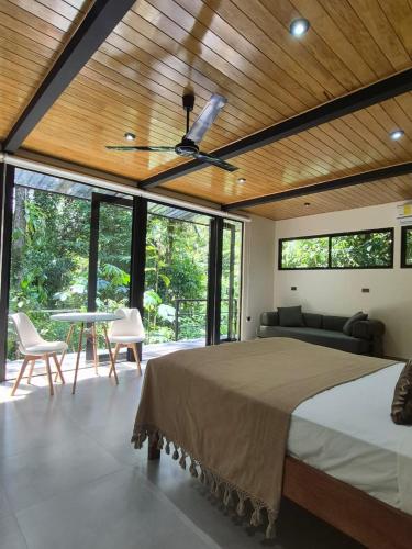 a bedroom with a bed and a ceiling fan at Fauna Lodge in Drake