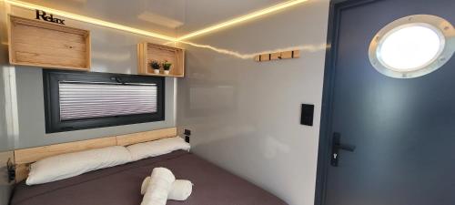 a small room with a bed and a window at SEA & SOUL SUITe in El Puerto de Santa María