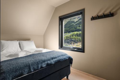 ein Schlafzimmer mit einem Bett und einem Fenster in der Unterkunft Trolltunga Harmony in Odda