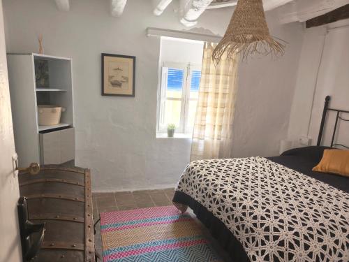 a bedroom with a bed and a window at Casa MANES in Pitres