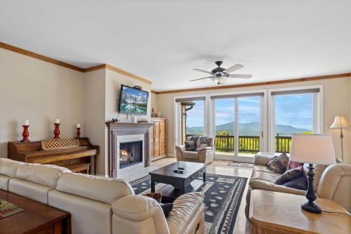a living room with a couch and a fireplace at Elderberry Escape in Beech Mountain