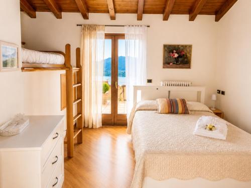 a bedroom with two beds and a window at Villa La Perla, Bellagio in Bellagio
