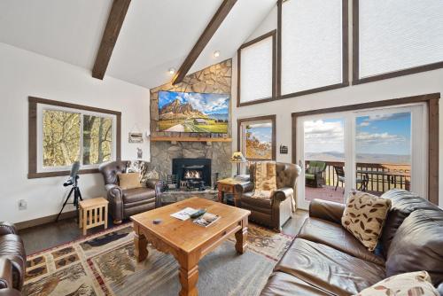 a living room with leather furniture and a fireplace at Four Diamond Escape in Seven Devils