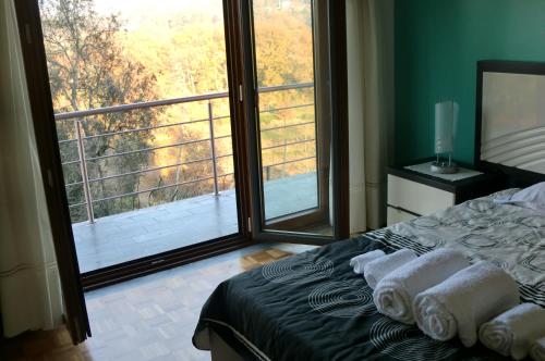 a bedroom with a bed and a large window at Quinta das Lindas 2 in Mondim de Basto