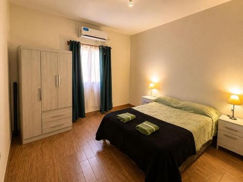 a bedroom with a bed and a dresser and a window at Hospedaje Don Felipe in Belén