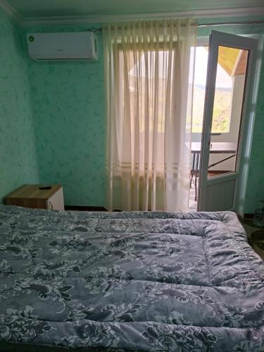 a bedroom with a bed and a window with a view at Адами Драхт in Garni