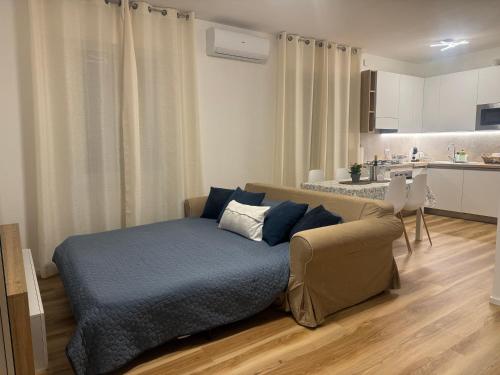 a living room with a bed and a kitchen at Iris home in Favaro Veneto