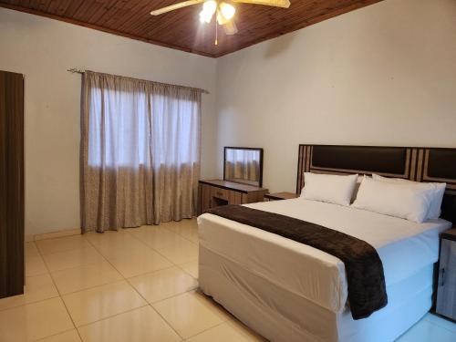 a bedroom with a large bed and a window at Mon Desir Estate - NR3 in Pietermaritzburg