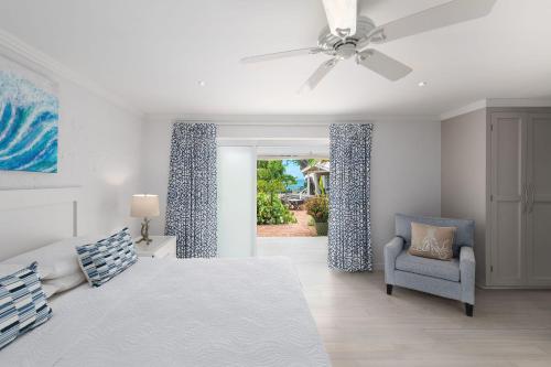 a bedroom with a bed and a ceiling fan and a chair at Southwinds - by ZenBreak in Saint Peter