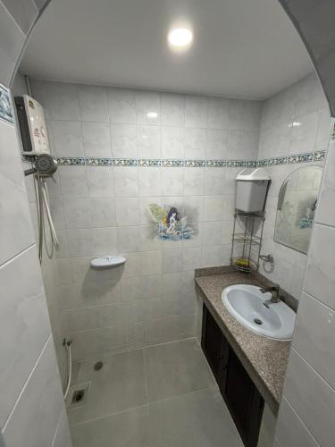 a bathroom with a sink and a mirror at Happy day in Nong Prue