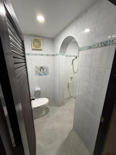 a bathroom with a toilet and a shower at Happy day in Nong Prue