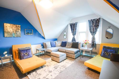 a large living room with a couch and chairs at Vibrant - 8ight Havens in Folkestone