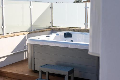 a bath tub in a room with a window at Vira Verso Est in Otranto